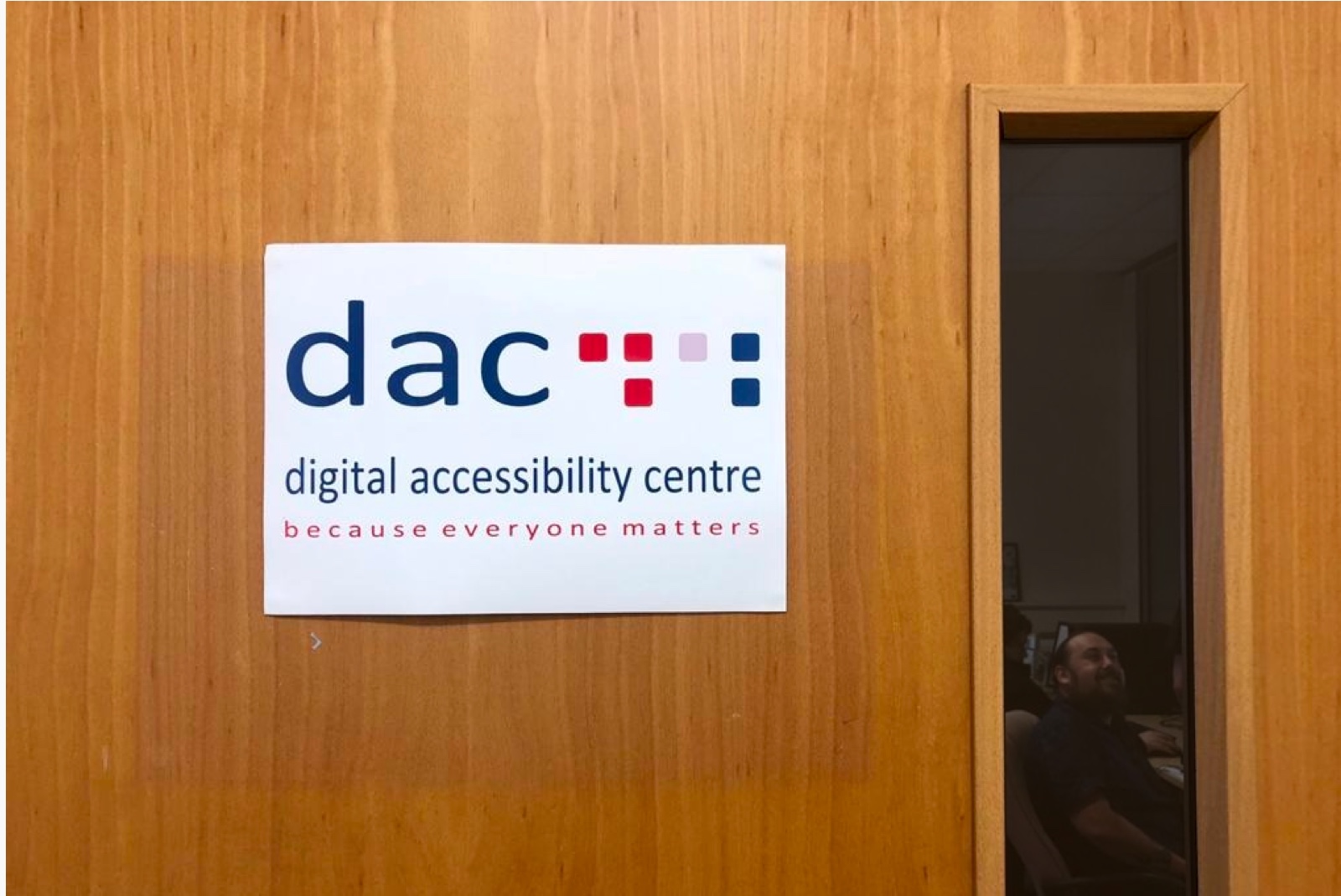 Photograph of a door with the DAC logo